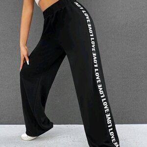 Black pants with white letters